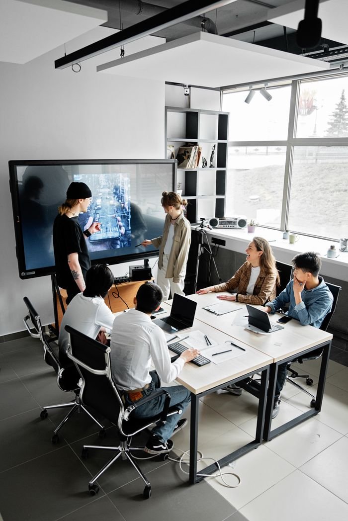 Mastering the First Impression: Your intriguing post title goes here Modern office meeting with diverse team using technology for collaboration.